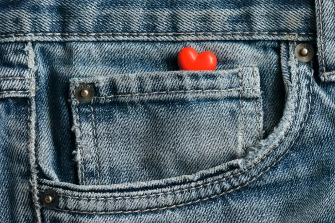 a red heart in the pocket of a pair of jeans
